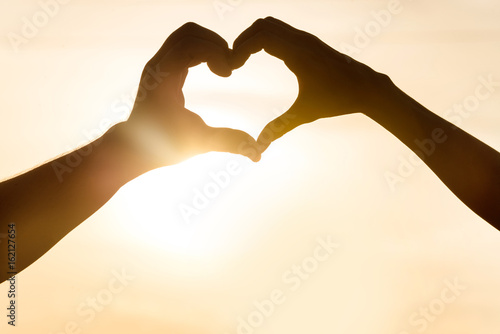 Silhouette of the heart hand gesture. Romantic love concept