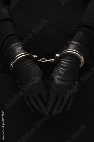 Silver handcuffs leather black gloves, concept