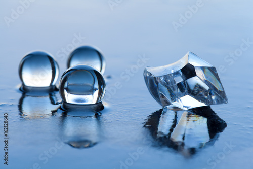 Water pearls abstract with plastic diamond and reflection on dark surface