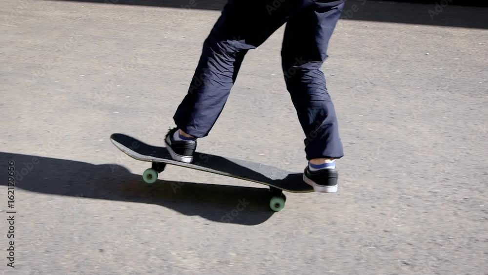 Crop man in motion of jumping on skateboard above ground Crop man in motion of jumping on skateboard above ground
