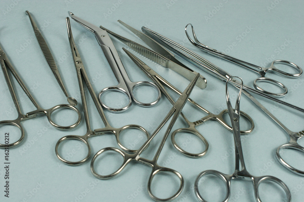 Medical surgical Instruments on blue background. Selective focus Medical surgical Instruments on blue background. Selective focus