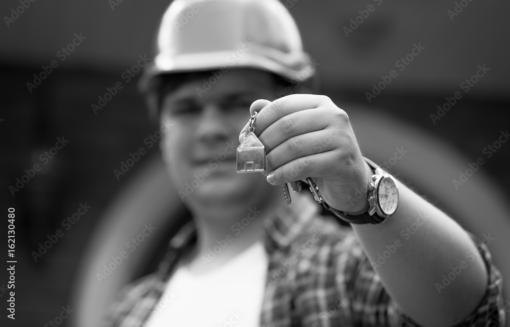 Black and white photo of building manager giving keys from new house Black and white photo of building manager giving keys from new house