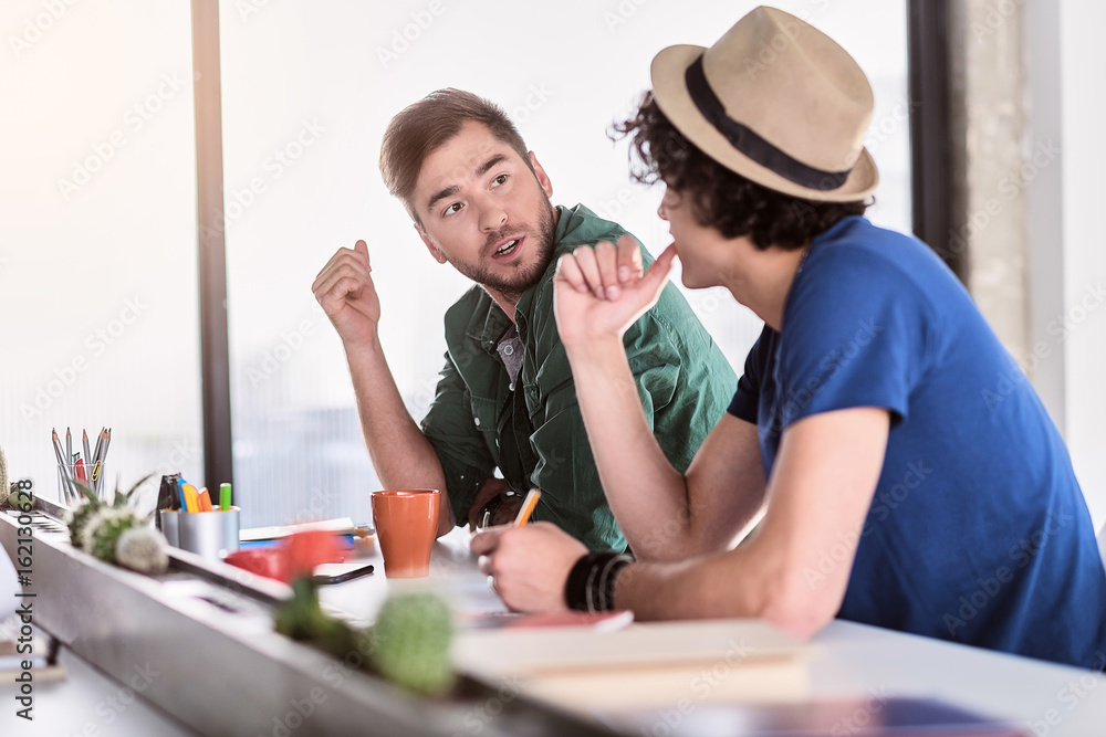 Businessman is interested in idea of coworker Businessman is interested in idea of coworker