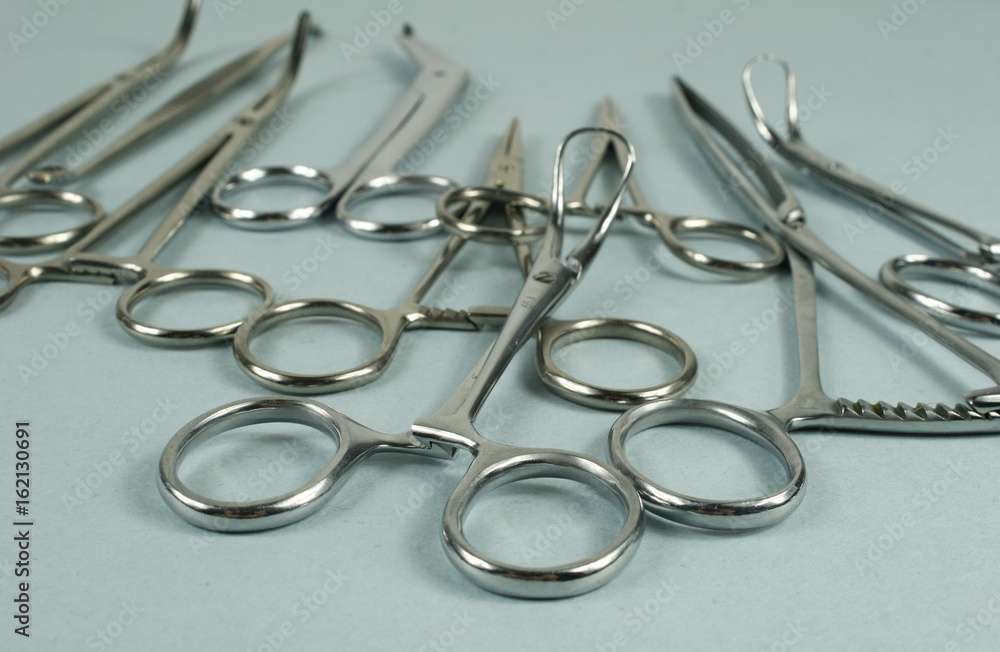 Medical surgical Instruments on blue background. Selective focus Medical surgical Instruments on blue background. Selective focus