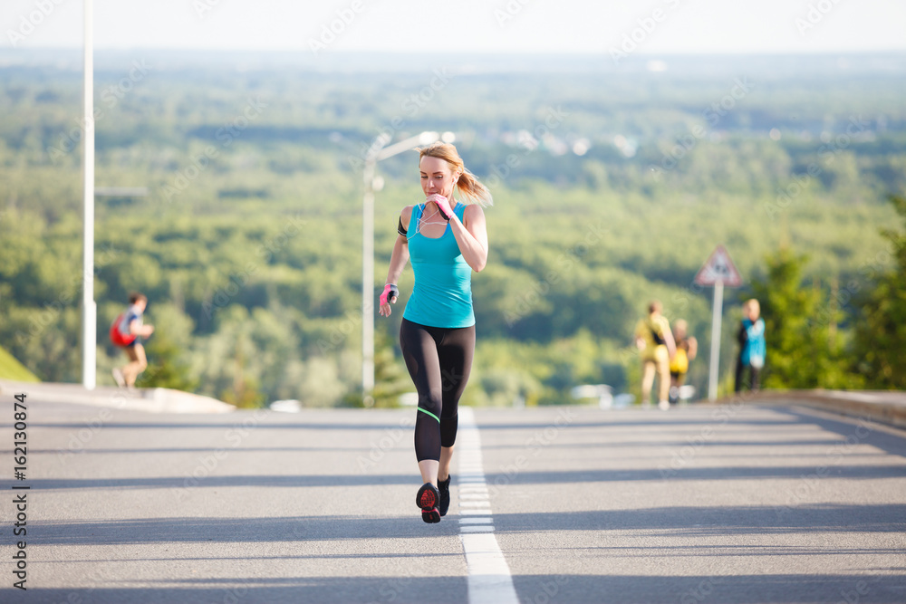 Young fitness healthy woman runner running on city