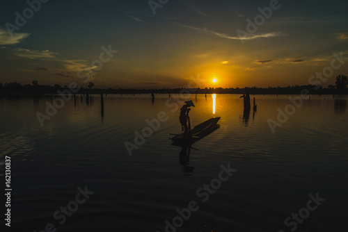 Silhouette Fisherman Fishing Nets on the boat.Thailand © chaisiri