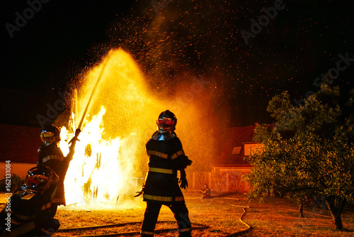 Saint Jean festival in french village. Flaming sculpture of horse.