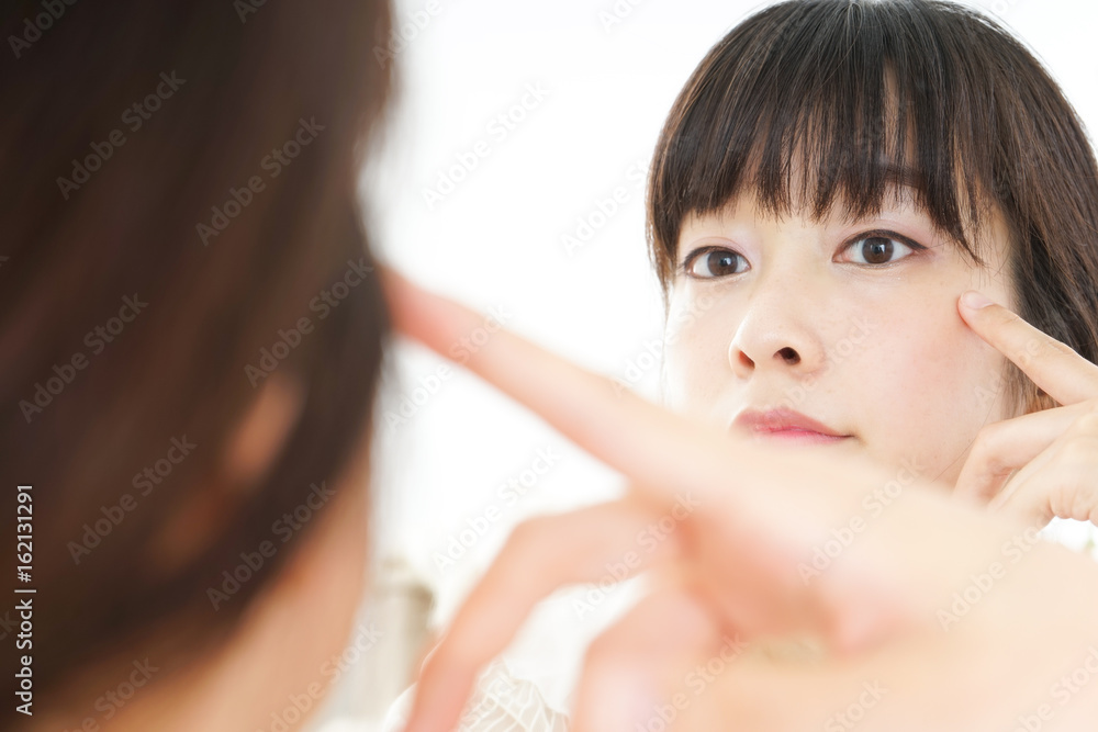 Young woman caring for skin problems