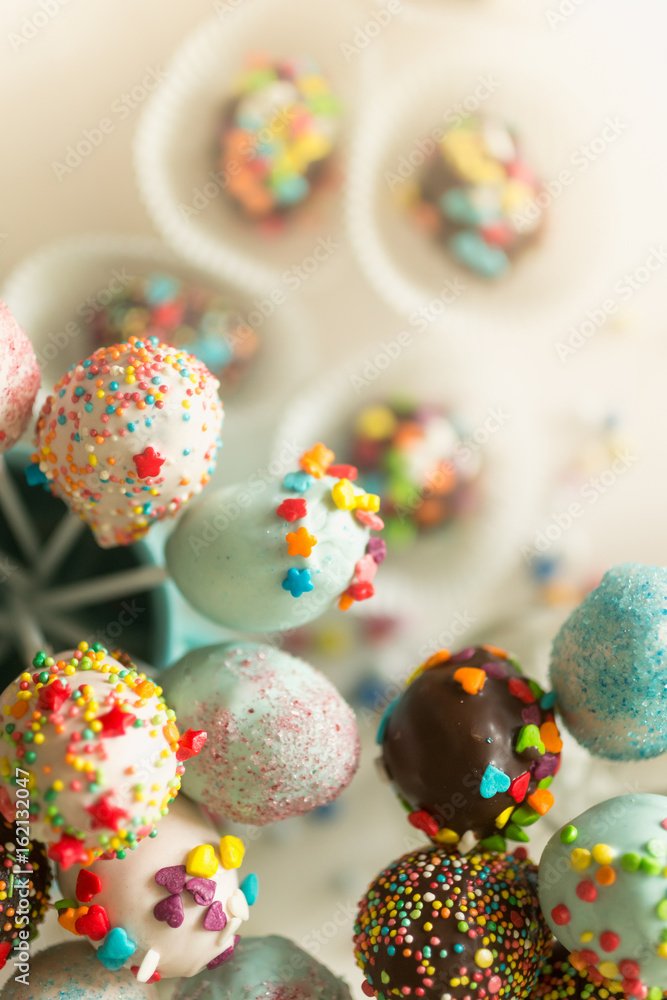 Fototapeta premium Colorful sprinkles on chocolate cake pops