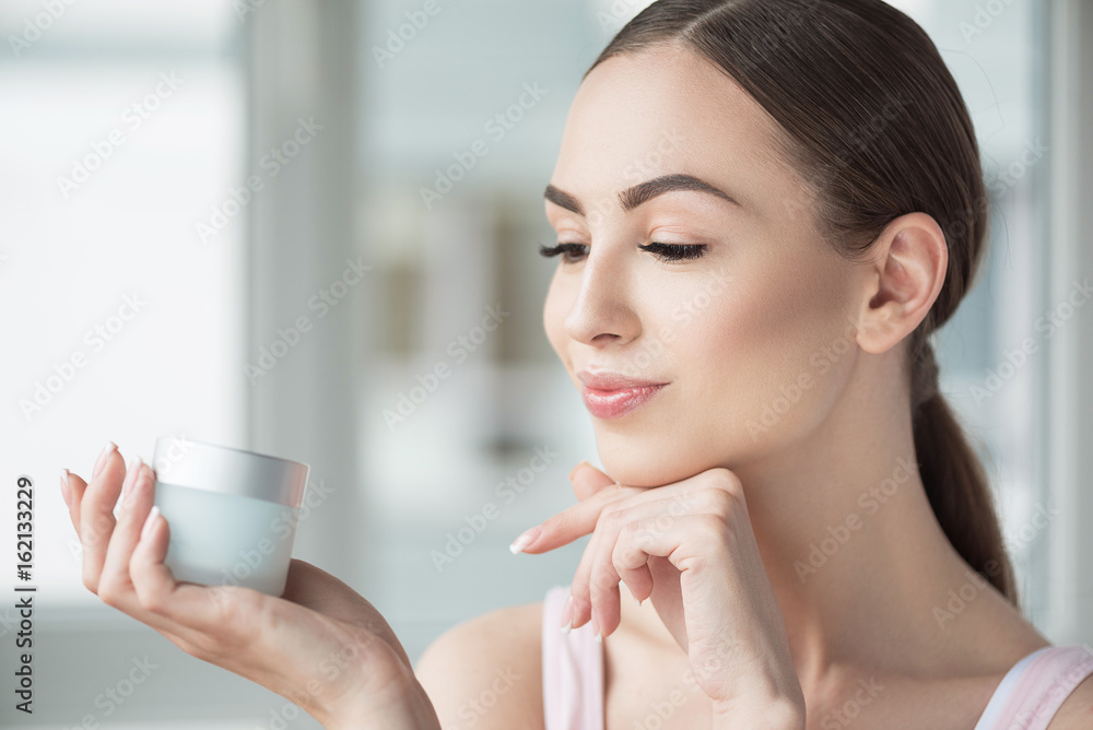 Happy beautiful woman enjoying using her make-up Happy beautiful woman enjoying using her make-up