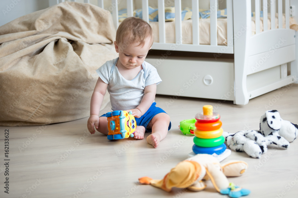 9 months old baby boy playing with toy car and toy tower 9 months old baby boy playing with toy car and toy tower