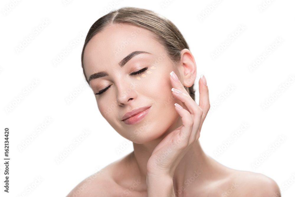 Cheery youthful lady enjoying using visage cosmetics