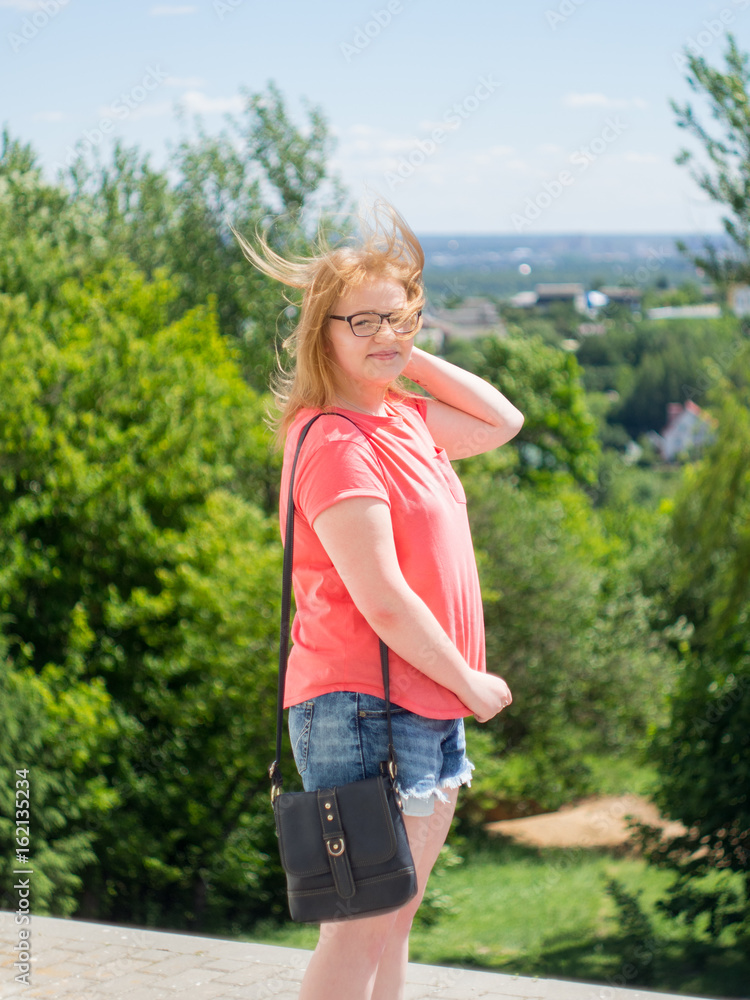 girl portrait in full growth. with glasses, a pink t-shirt smiling Sunny day girl portrait in full growth. with glasses, a pink t-shirt smiling Sunny day