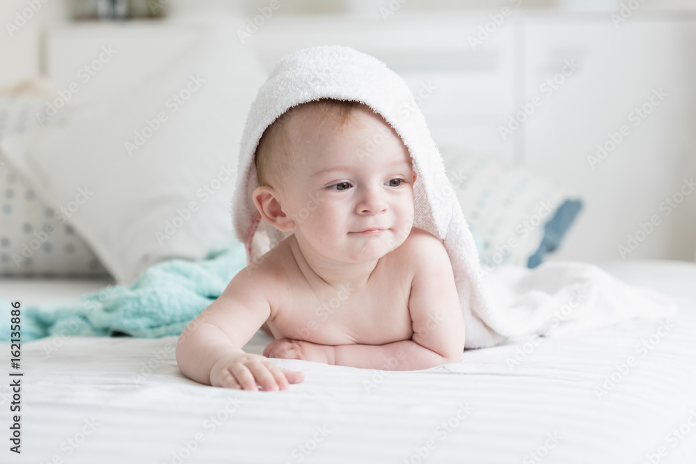 Happy 9 months old baby looking under towel after having bath Happy 9 months old baby looking under towel after having bath
