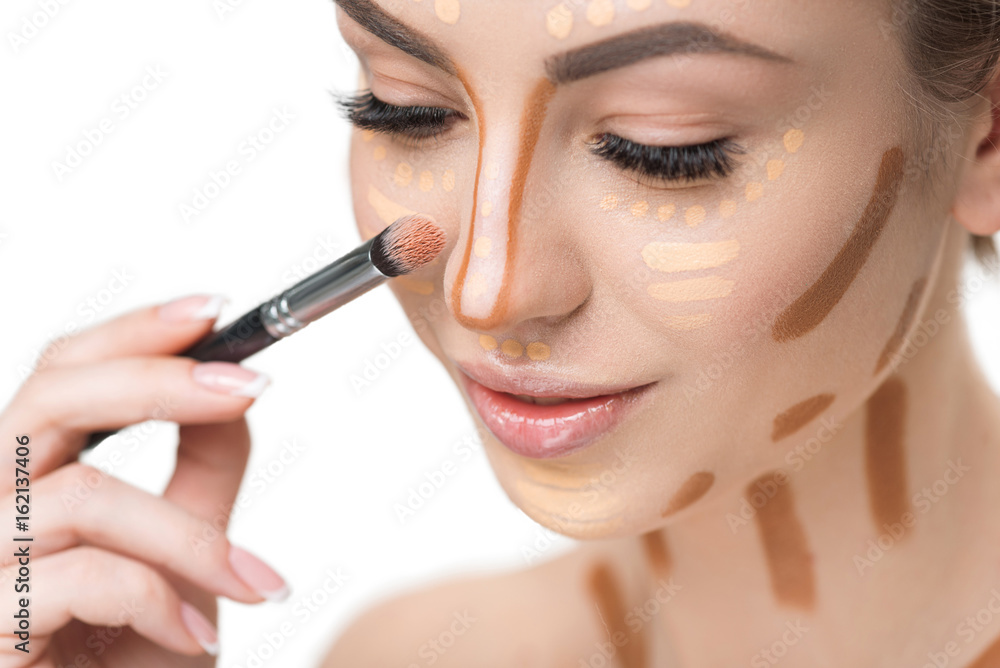 Beautiful young woman doing make-up Beautiful young woman doing make-up