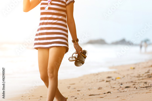 Asia woman walking at beach with blue sea and sky
