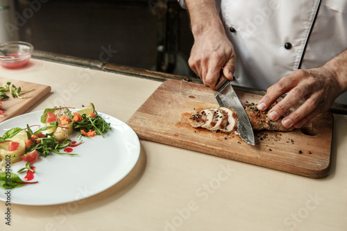  Mature man professional chef cooking meal indoors