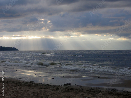 Summer beach coast with dark clouds on the sky