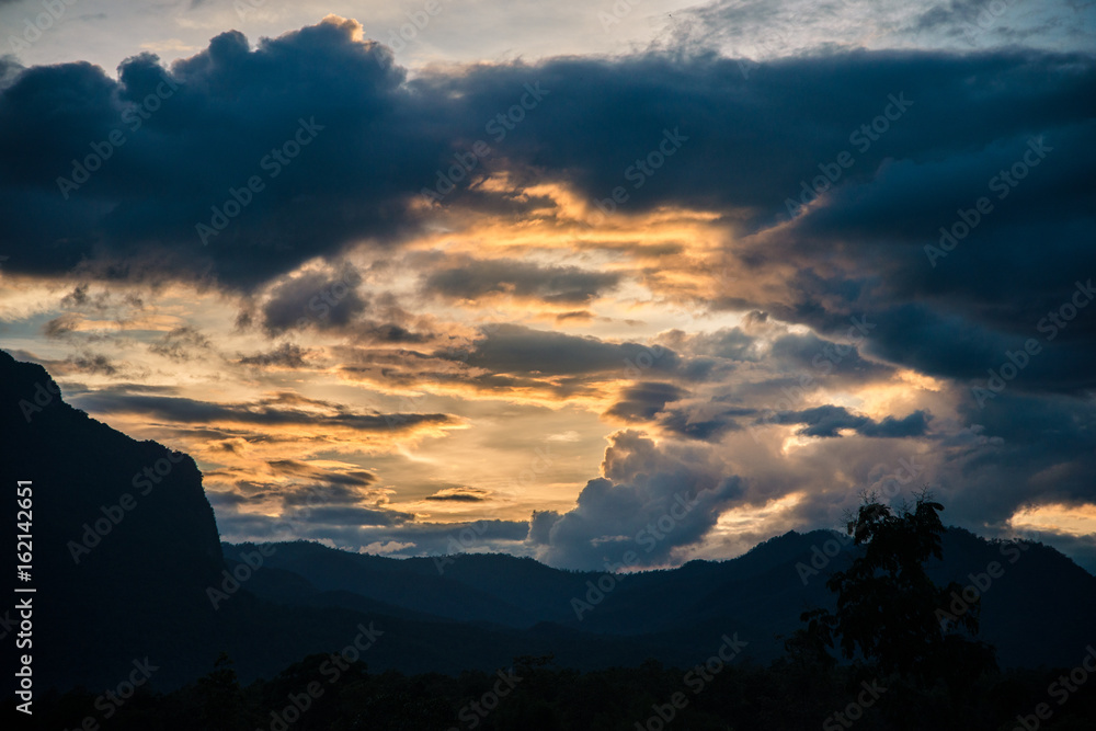 High mountain with clouds in twilight sky