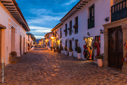 Evening moody view of a cobbled street in colonial town Villa de Leyva, Colombia. photo