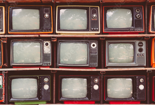 A lot of colorful old television decorate in coffee shop vintage tone.