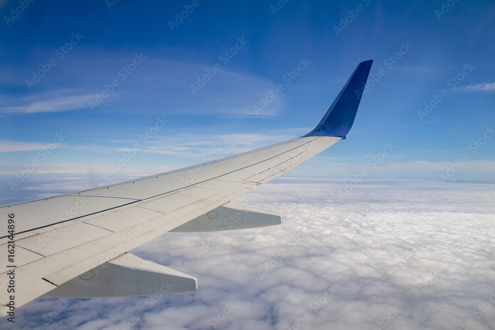 Airplane wing on the sky and over sea with clouds Airplane wing on the sky and over sea with clouds