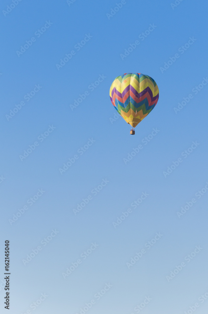 Isolated Hot Air Balloon in a blue sky Isolated Hot Air Balloon in a blue sky