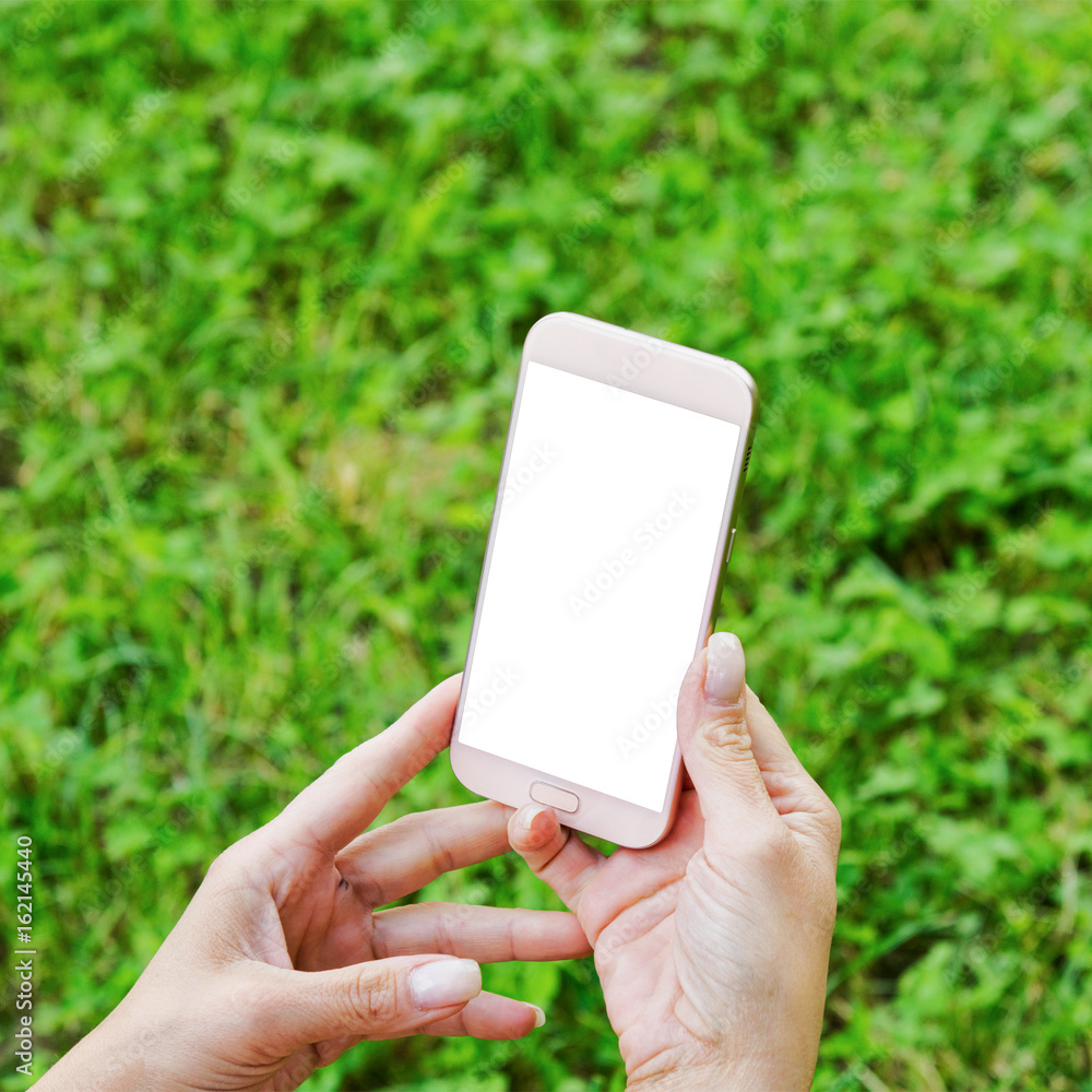 Mobile phone in women hand and blurred background