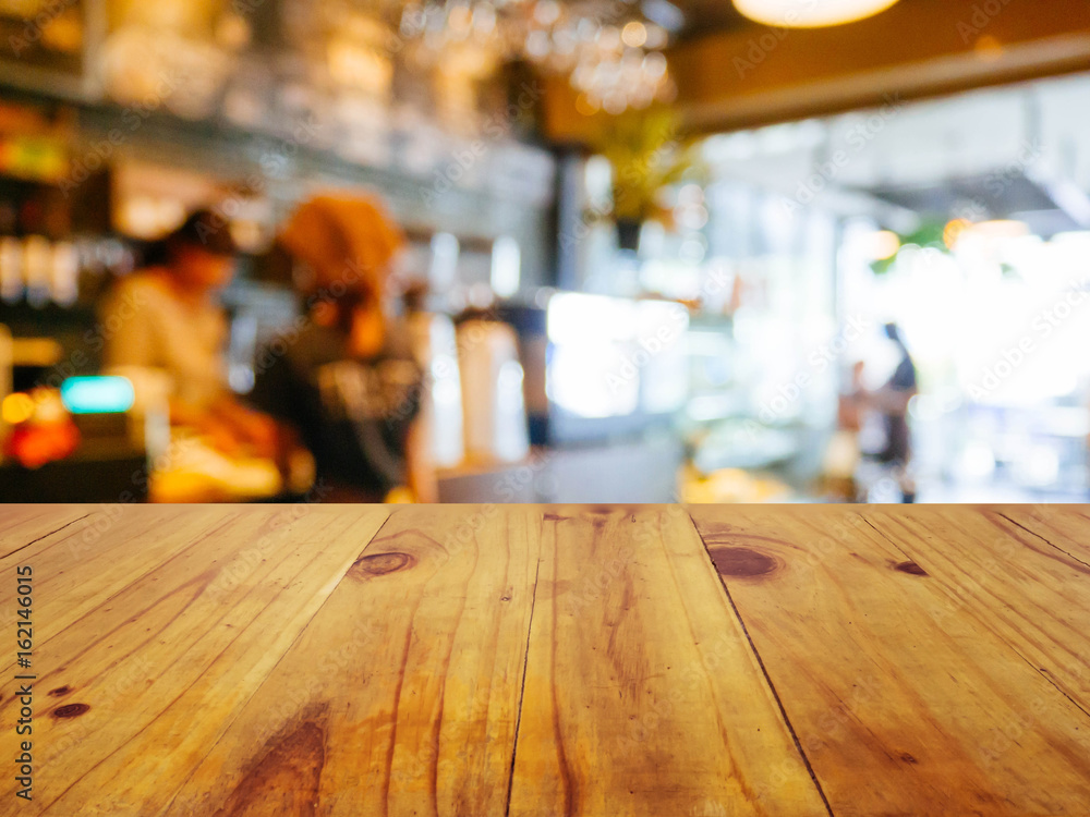 Wooden board empty table in front of blurred background. Perspective brown wood over blur in coffee shop or cafe- can be used for display or montage your products.Mock up your products.Vintage filter.