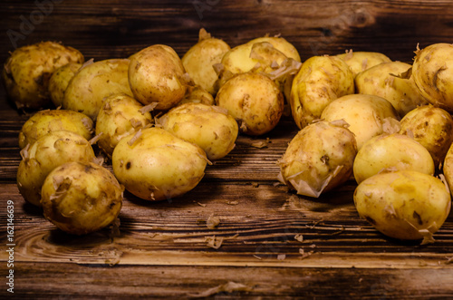 Pile of the young potato on wooden table
