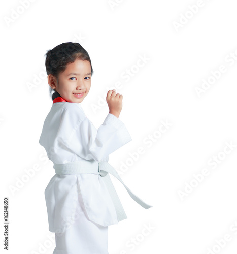 Happy Asian little girl is smile and showing fist for guarding in taekwondo uniform isolated on white background