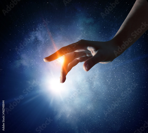 Hand touching the moon