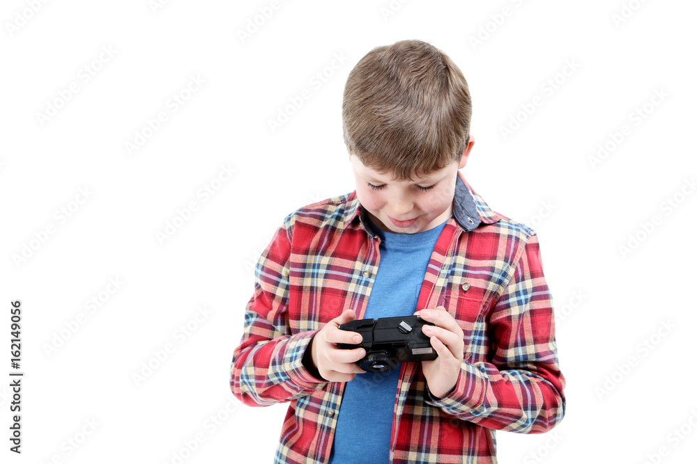 Young boy with camera on a white background