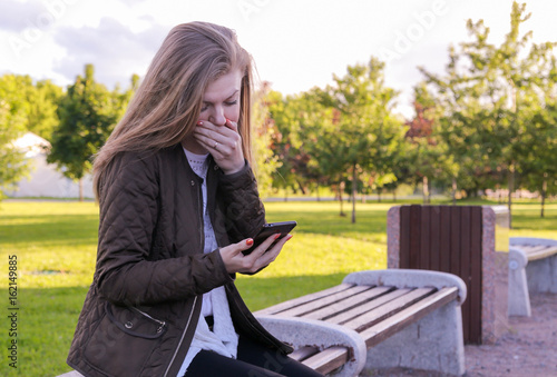The girl reads a sad text message