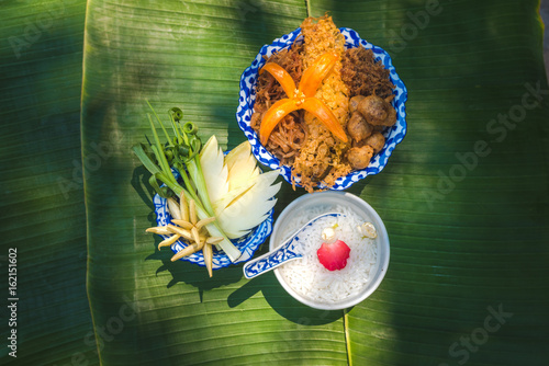 Thai Royal Cuisine. dry-cooked rice in cold water, eaten with condiments, rice in ice water, Food for summer season,Thailand © Theerawat