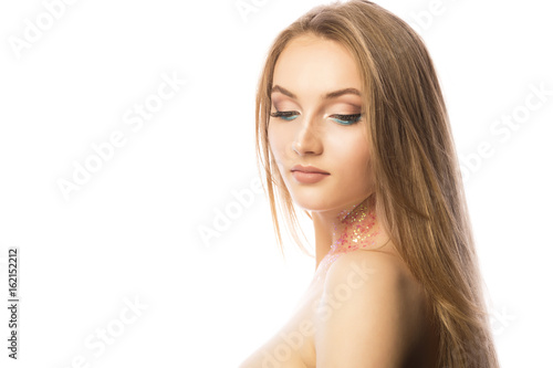 Beautiful woman face with professional makeup and glitter on her neck