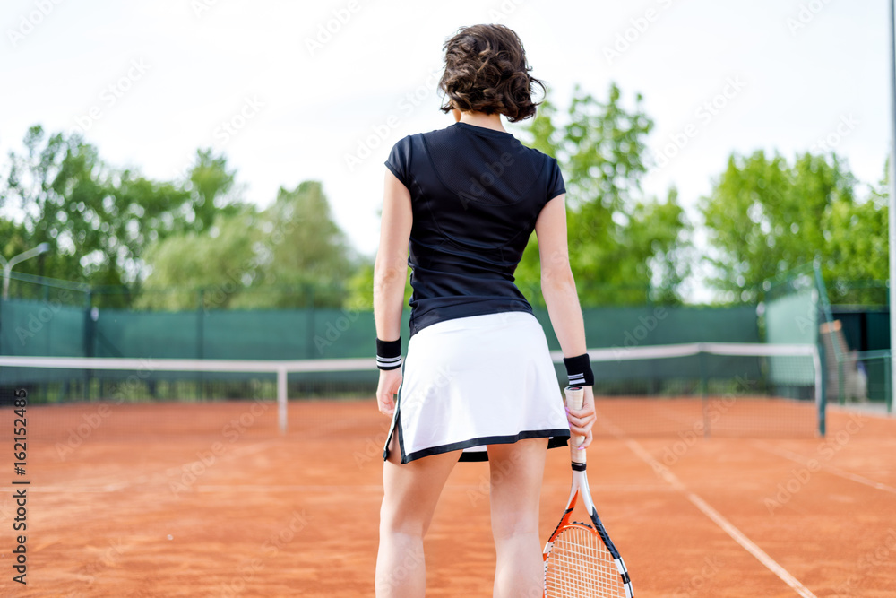 Beautiful young girl on the open tennis court Beautiful young girl on the open tennis court