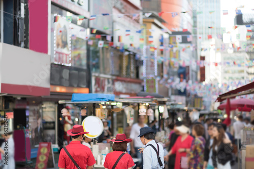 crowd of people and neon advertising on Seoul touristic road