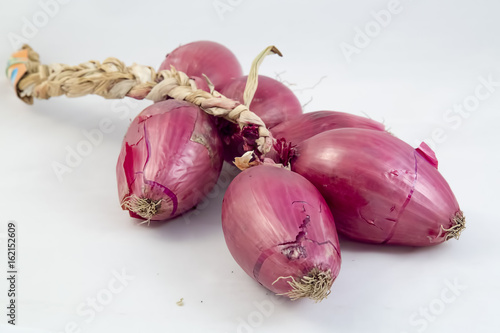 Pink italian onion braid on white background