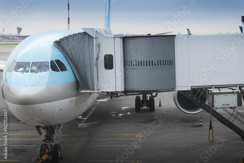 Aircraft standing at gate and being loaded with luggage