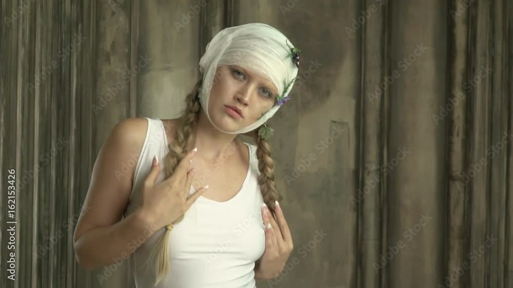 A woman with a bandaged head smoothly moves her body A woman with a bandaged head smoothly moves her body