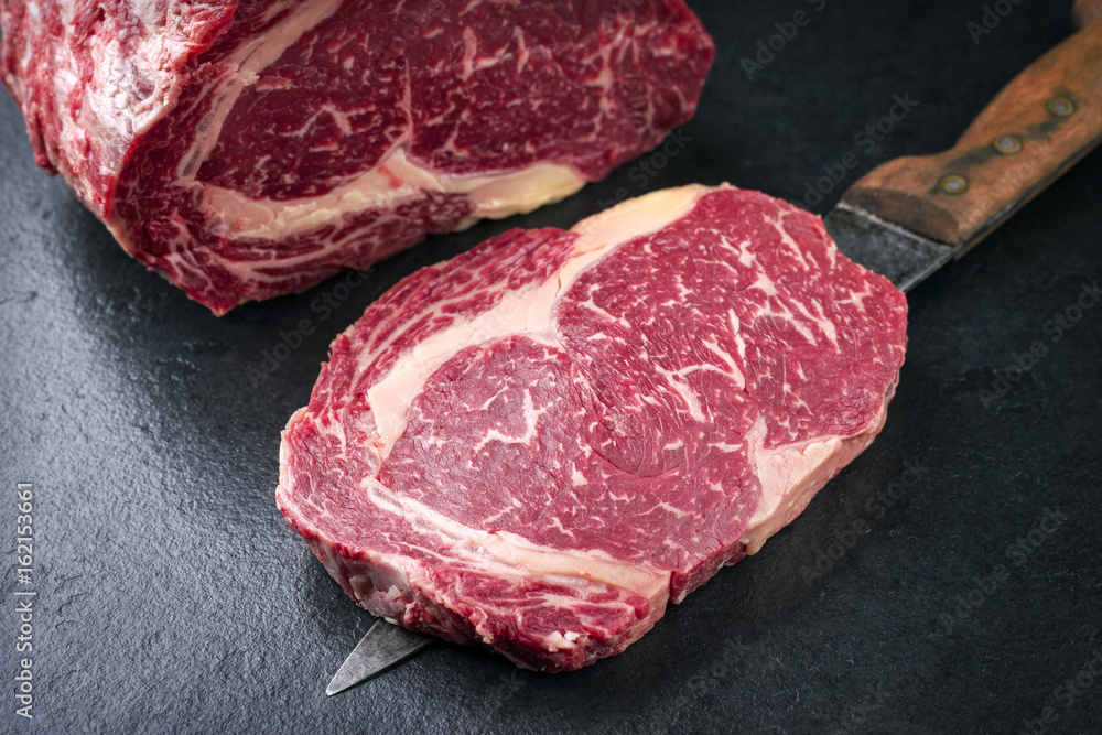 Raw dry aged Kobe Entrecote Steak as close-up on a slate