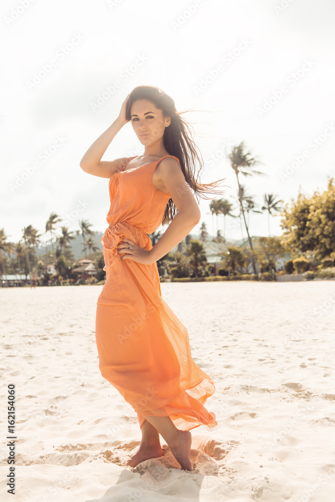 Young sexy hipster woman in fashion light summer dress walking by