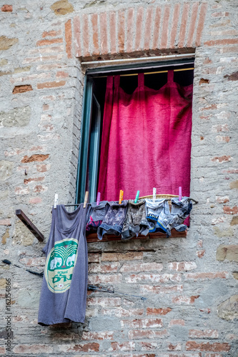 Italian window with hanging clothes photo