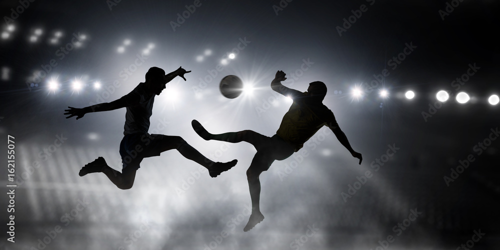Silhouettes of two soccer players . Mixed media