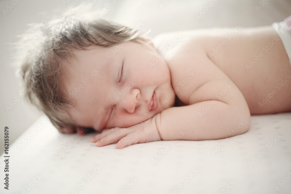 adorable baby sleeping on stomach, close-up adorable baby sleeping on stomach, close-up