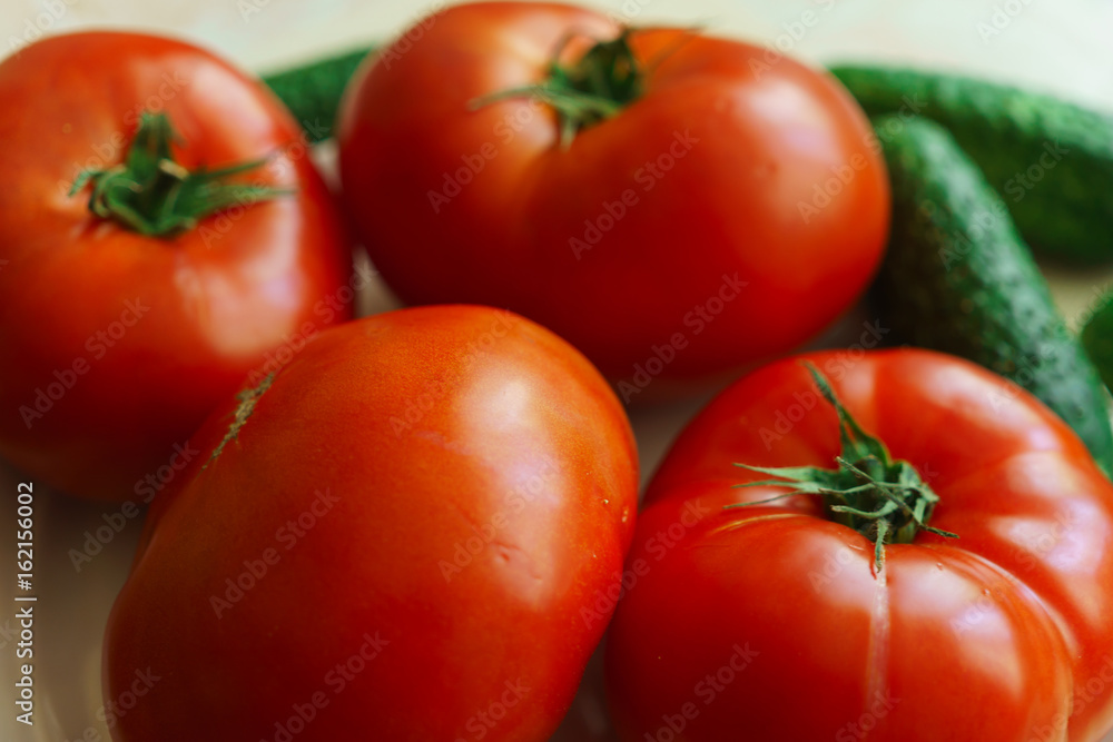 Fresh, ripe red tomatoes and pickled cucumbers. Fresh, ripe red tomatoes and pickled cucumbers.