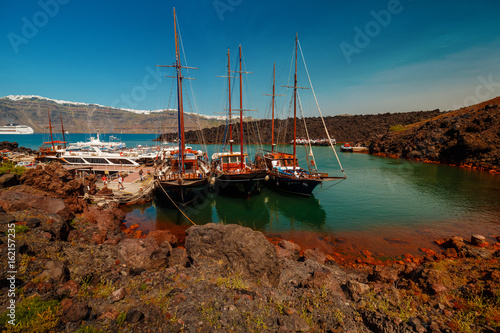 A panoramic wide shot showing the volcanic desert island of Thirassia near the popular Greek island of Santorini photo