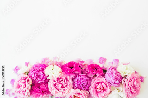 Fototapeta Naklejka Na Ścianę i Meble -  Pink flowers - roses, peonies and ranunculus on white background. Floral composition. Flat lay, top view.