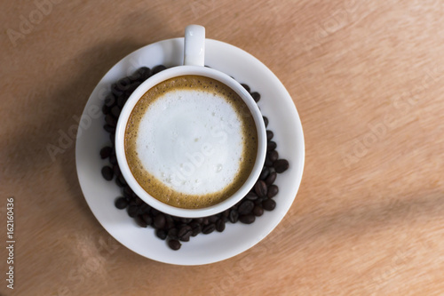 Hot coffee in a white cup on the table.